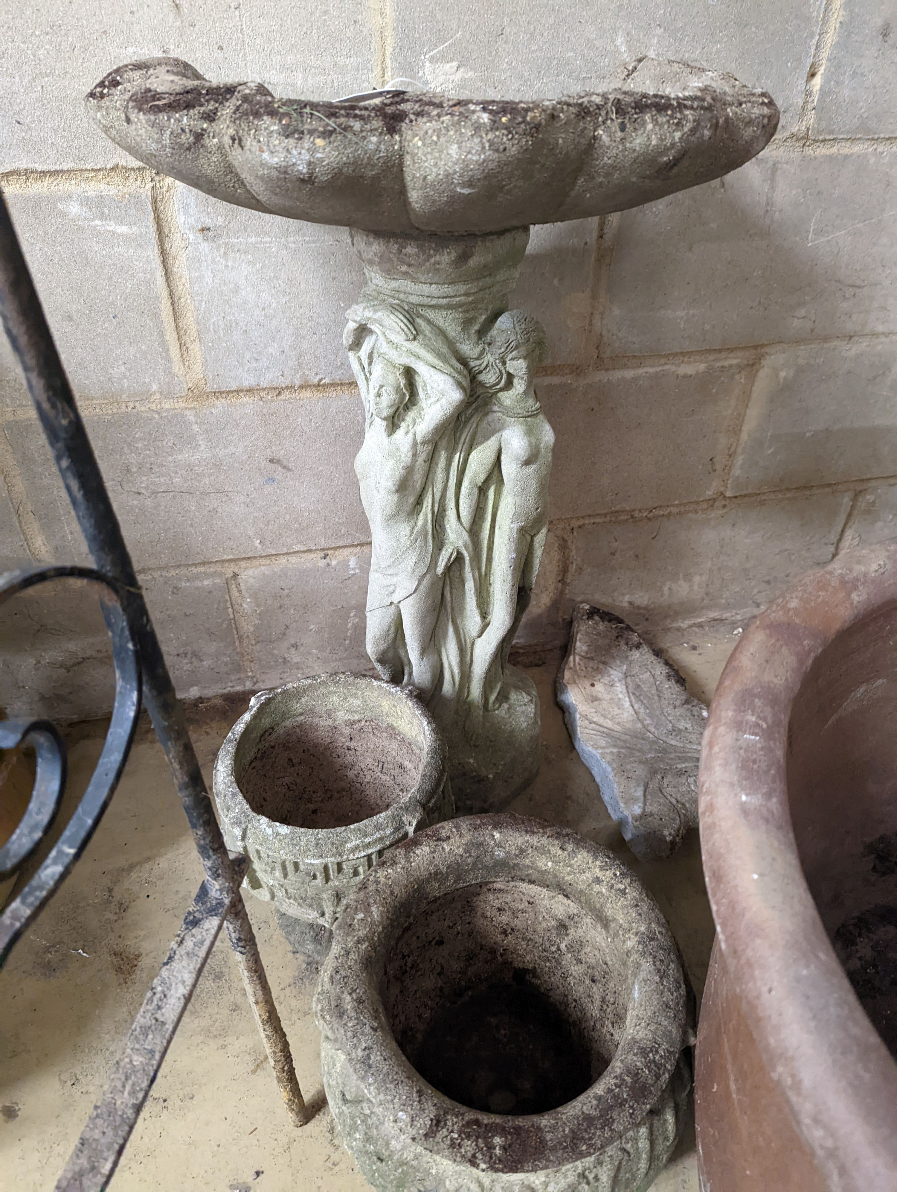 A reconstituted stone bird bath, (damaged) height 80cm together with two circular garden planters